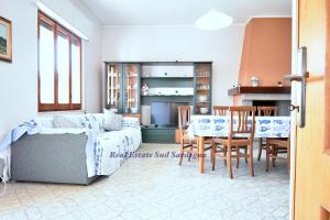 a living room with a couch and a table and chairs at Casa Elena 1 in Pula