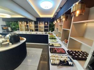 a restaurant kitchen with a buffet of food at GRAND BELLİ OTEL in Altındağ