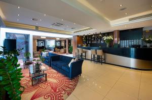 a lobby of a hotel with a bar in the middle at Outlet Hotel Polgár in Polgár