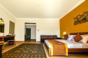 a hotel room with a bed and a desk at Xperience St. George Sharm El Sheikh in Sharm El Sheikh