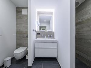 a bathroom with a sink and a toilet and a mirror at Waterkant in der Seefahrtschule in Wustrow +13 photos
