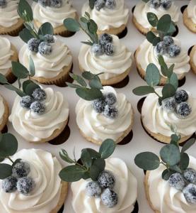 a bunch of cupcakes with white frosting and blueberries on them at Eternity Athens -Opening 2025- in Athens