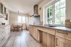 a kitchen with a sink and a table in it at Landhaus Markerup in Husby +42 photos