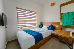Postel nebo postele na pokoji v ubytování Breeza Homes, Technopark, Trivandrum