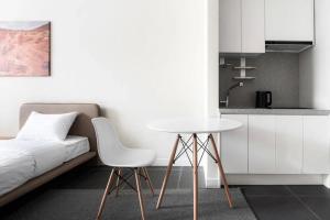 a bedroom with a bed and a white table and chair at HIGHVILL Hotel by AG Hotels Group in Astana