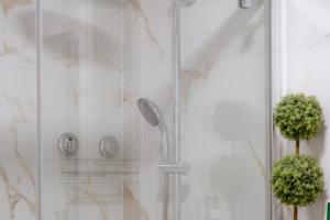 a shower with a shower head in a bathroom at Paraiso vista Incrivel in Costa da Caparica