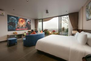 a bedroom with a large white bed and a tv at Hanoi Riverview Boutique Hotel & Apartment in Hanoi