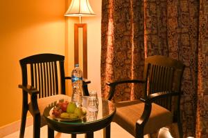 a table with a bowl of fruit and a bottle of water at Xperience St. George Sharm El Sheikh in Sharm El Sheikh