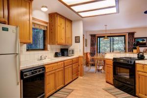 a kitchen with wooden cabinets and a stove top oven at Cecil's Cabin in Wawona