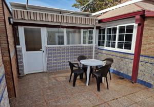 a patio with a table and chairs on a patio at Villa Alma in Coslada