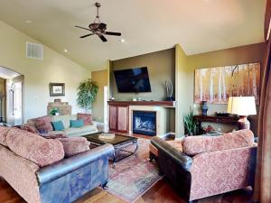 a living room with two couches and a fireplace at High Expectations in Ruidoso