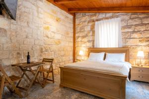 a bedroom with a bed and a table with a chair at Via Maria Boutique Suites - Free Parking in Haifa