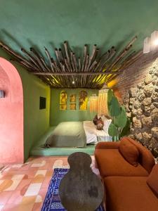 a bedroom with a bed and a couch in a room at Casa Amina in Chefchaouene