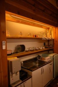 a small kitchen with a sink and a microwave at Yeoyeoje - Hanok Accommodation with the atmosphere of Hwaseong Fortress Road in Suwon, a UNESCO World Heritage in Suwon +33 photos