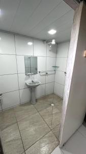 a bathroom with a sink and a mirror at Pousada Aventurine Noronha in Fernando de Noronha +61 photos