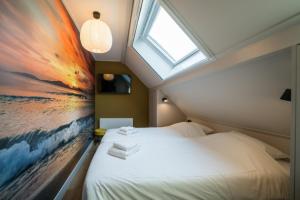 a bedroom with a bed with a painting on the wall at Sun (6p) in Ballum