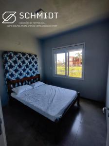 Ένα ή περισσότερα κρεβάτια σε δωμάτιο στο Casa Arroio do Sal