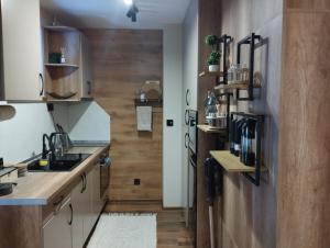 a kitchen with a sink and a refrigerator at студио Е 13 in Pamporovo