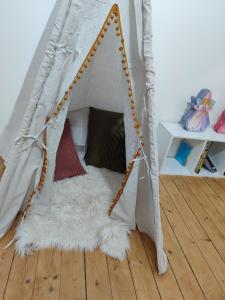 a tent with a white rug in a room at Logement entier - Centre Fécamp - 67 Vanessa in Fécamp +24 photos