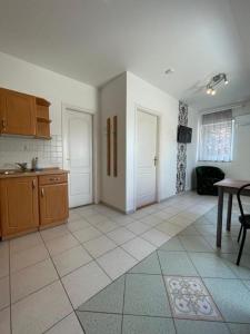 a room with a kitchen with a table and a table at Zámor 10 Apartmant in Keszthely