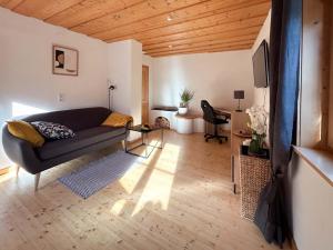 a living room with a couch and a table at Appartementgitti in Hallstatt
