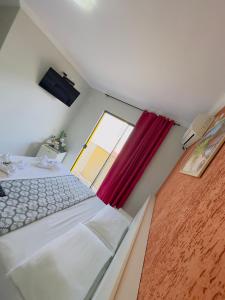 a small room with a bed and a window at Hotel Brasília Park in Novo Gama +32 photos