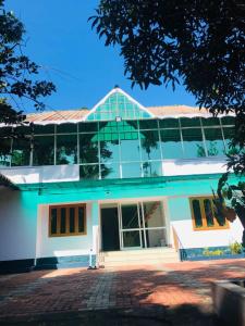 a large white building with a large window at Ghala Homestay in Anachal