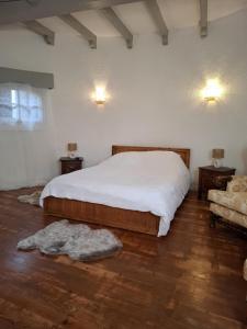 a bedroom with a bed and two tables and a couch at La Tour in Béziers +13 photos