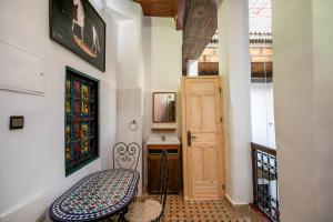 a hallway with a bench and a door at Riad Alouch in Fès +42 photos