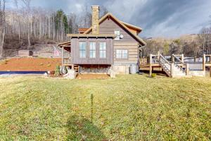 a house on a hill with a yard at Moss Creek Cabin in Sylva