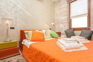 a bedroom with two beds with towels on them at Apartment Lux Rovinj in Rovinj