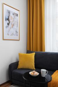 a living room with a blue couch and a table at Apartment Pekarska 29 by Goodnite cz in Brno