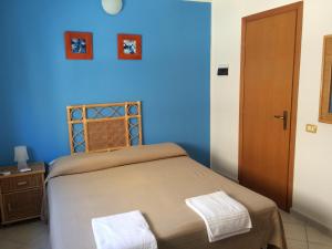 Letto o letti in una camera di Hotel Il Triangolo