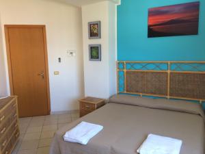 Letto o letti in una camera di Hotel Il Triangolo