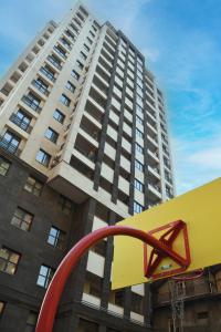 a tall apartment building with a red object in front of it at Newly Renovated Condo Steps to Republic Square in Yerevan
