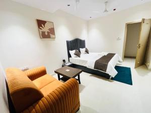 a living room with a bed and a couch at Hotel Royal Sky in Morbi