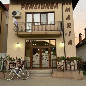 a bike parked in front of a building at Pensiunea Maria in Călimăneşti