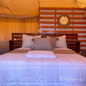 a large bed in a room with two bedsvisor at Rimal tata camp in Migourdâne +69 photos