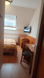 Postel nebo postele na pokoji v ubytování Hotel Baross