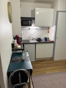 a small kitchen with a table and a counter at Magnifique studio en bord de mer vue montagne in Saint-Cyprien +3 photos