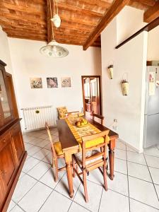 a dining room with a wooden table and chairs at Momenti Suite in Piombino