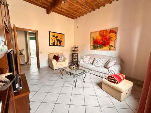 a living room with a couch and a table at Momenti Suite in Piombino