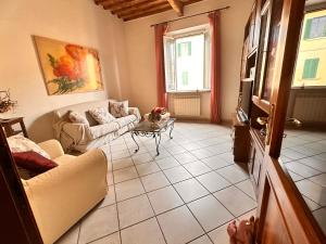 a living room with a couch and a table at Momenti Suite in Piombino +6 photos