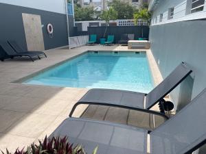 a swimming pool on the side of a building at Karaibes Hotel in Le Gosier