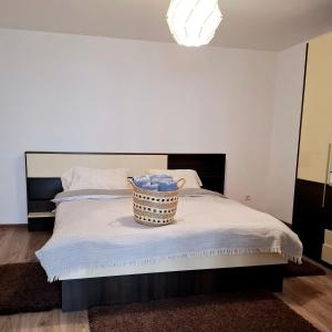 a bedroom with a bed with a basket on it at Casuta de sub munte in Buzau