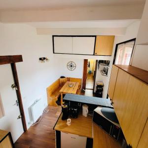 a small kitchen with a table and a dining room at Au Chant des Mouettes in Cabourg +13 photos