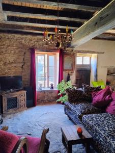 a living room with a couch and a chandelier at BNB Calme in Saint-Marien +18 photos