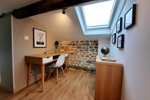 a home office with a desk and a window at Grand appartement proche métro avec place de parking in Lyon
