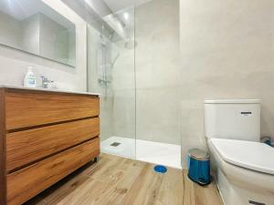 a bathroom with a shower and a toilet and a sink at Casa Postiguillo in Manzanares el Real