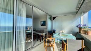 un balcone con tavolo e sedie e una sala da pranzo di LA RESIDENCE COSTA PLANA, Appt 204, VUE SUR LA MER a Cap d'Ail